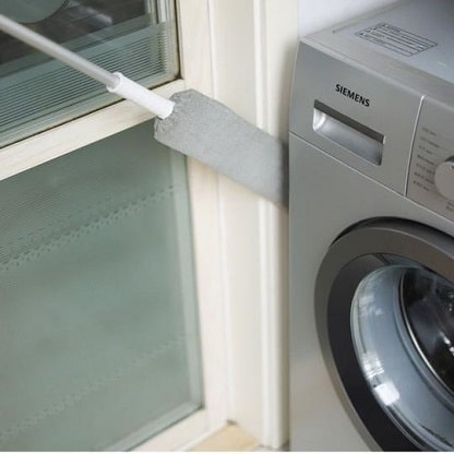 Ausziehbares Staubtuch neben der Waschmaschine