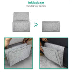 Lichtgrauer BedCaddy faltbar für Reisen und auch 2 kleine Bilder, die an einer Bank hängen.
