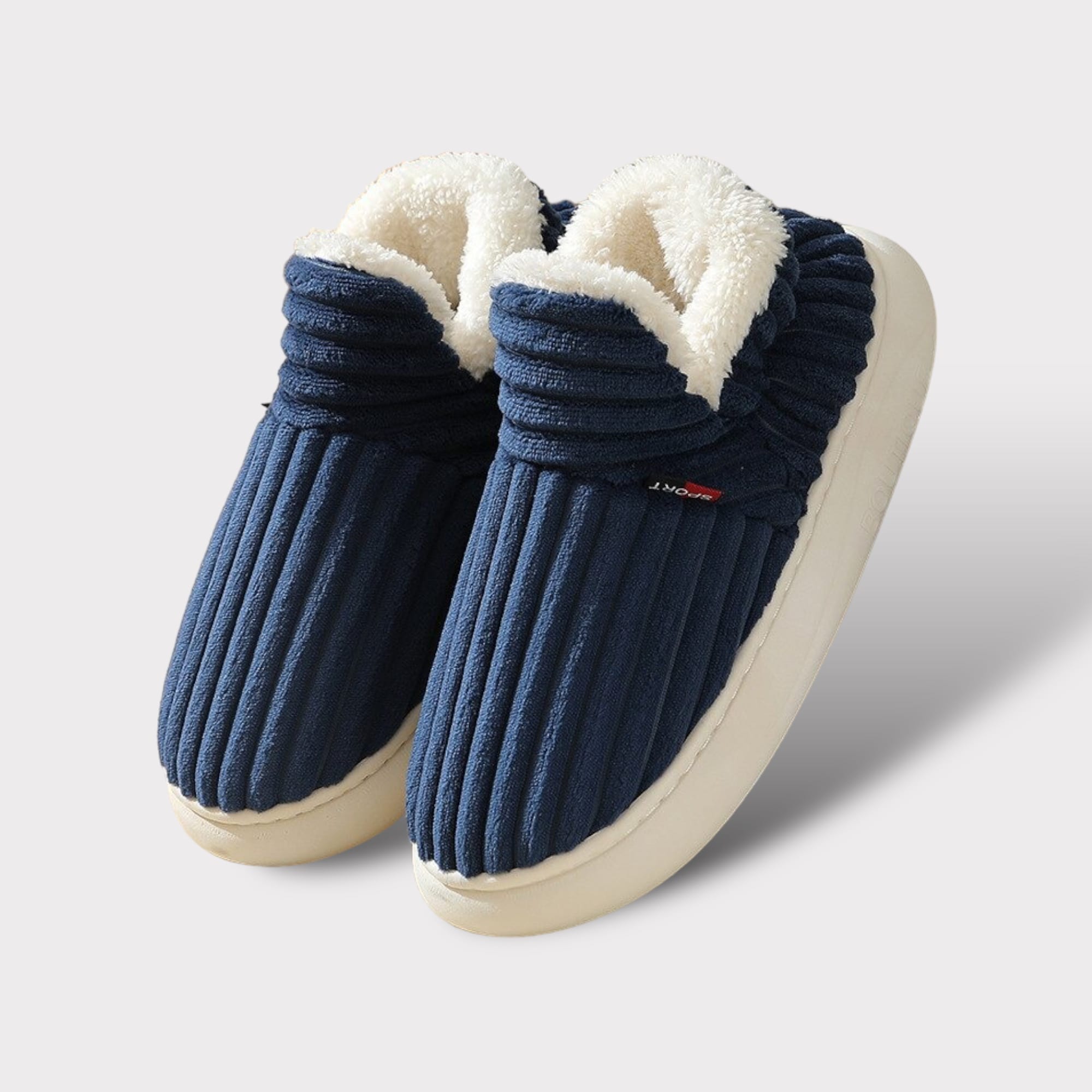 Blaue Komfort-Fleece-Hausschuhe mit weißem Fleece-Futter und weißer Gummisohle.