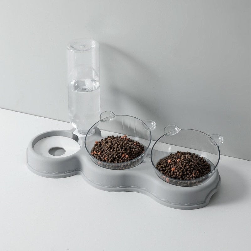 Graue Futterschale mit Wasserspender und Futterbehältern.