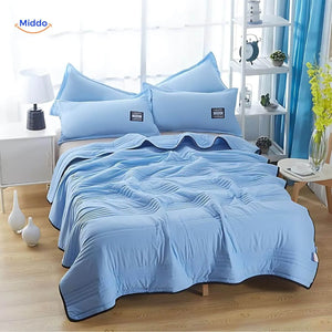 Coolwave Kühldecke in der Farbe hellblau auf einem gemachten Bett
