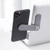Telefon mit grauem MagnetClip am Laptop befestigt.