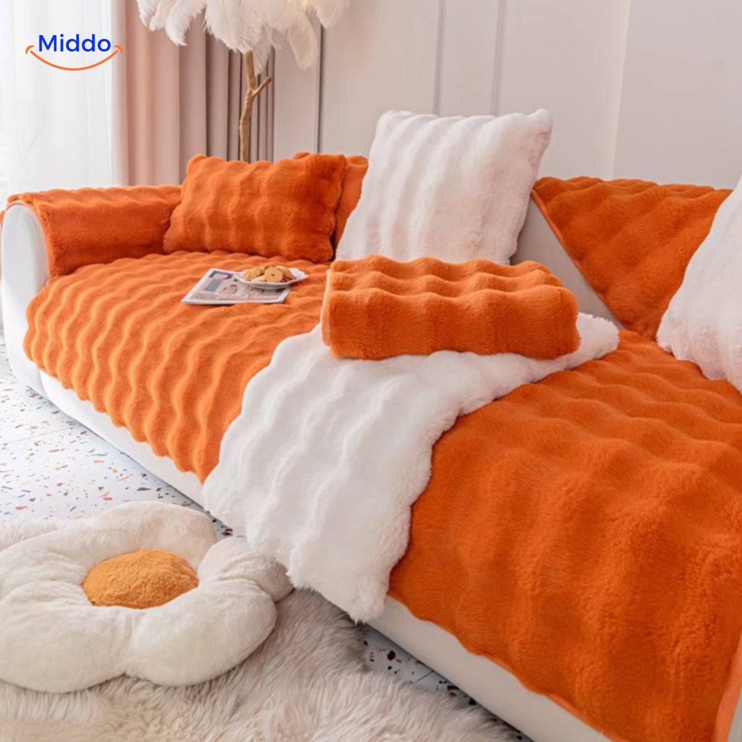 Orange und weiße Sofaschutzhülle mit passenden Kissen.