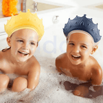 Zwei lachende Kinder in der Badewanne mit gelben und blauen krönchenförmigen Badehüten
